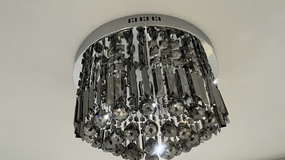 Crystal flush-mount ceiling light installed on a smooth ceiling