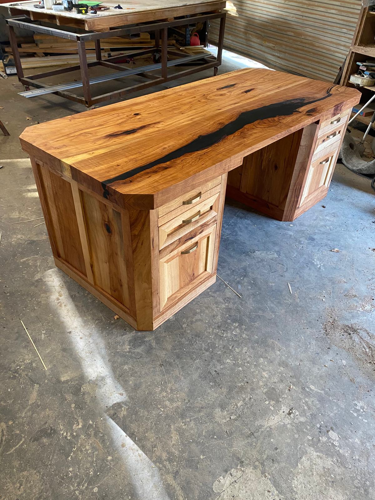 Live-edge desk with a dark resin river top and two drawer pedestals